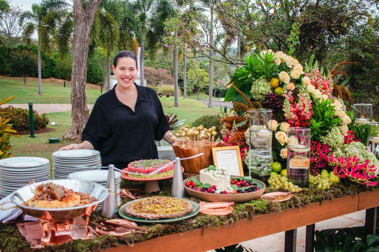 Mesa de evento com buffet e decoração floral